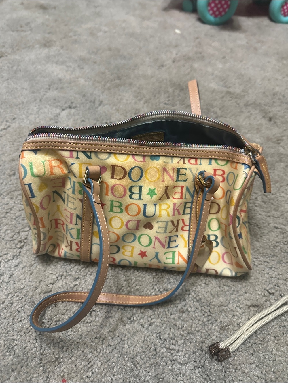 Dooney & Bourke Cream Multicolor Logo Satchel does have yellowing